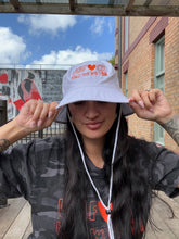 Load image into Gallery viewer, Unf*ck The World Bucket Hat in White w Orange
